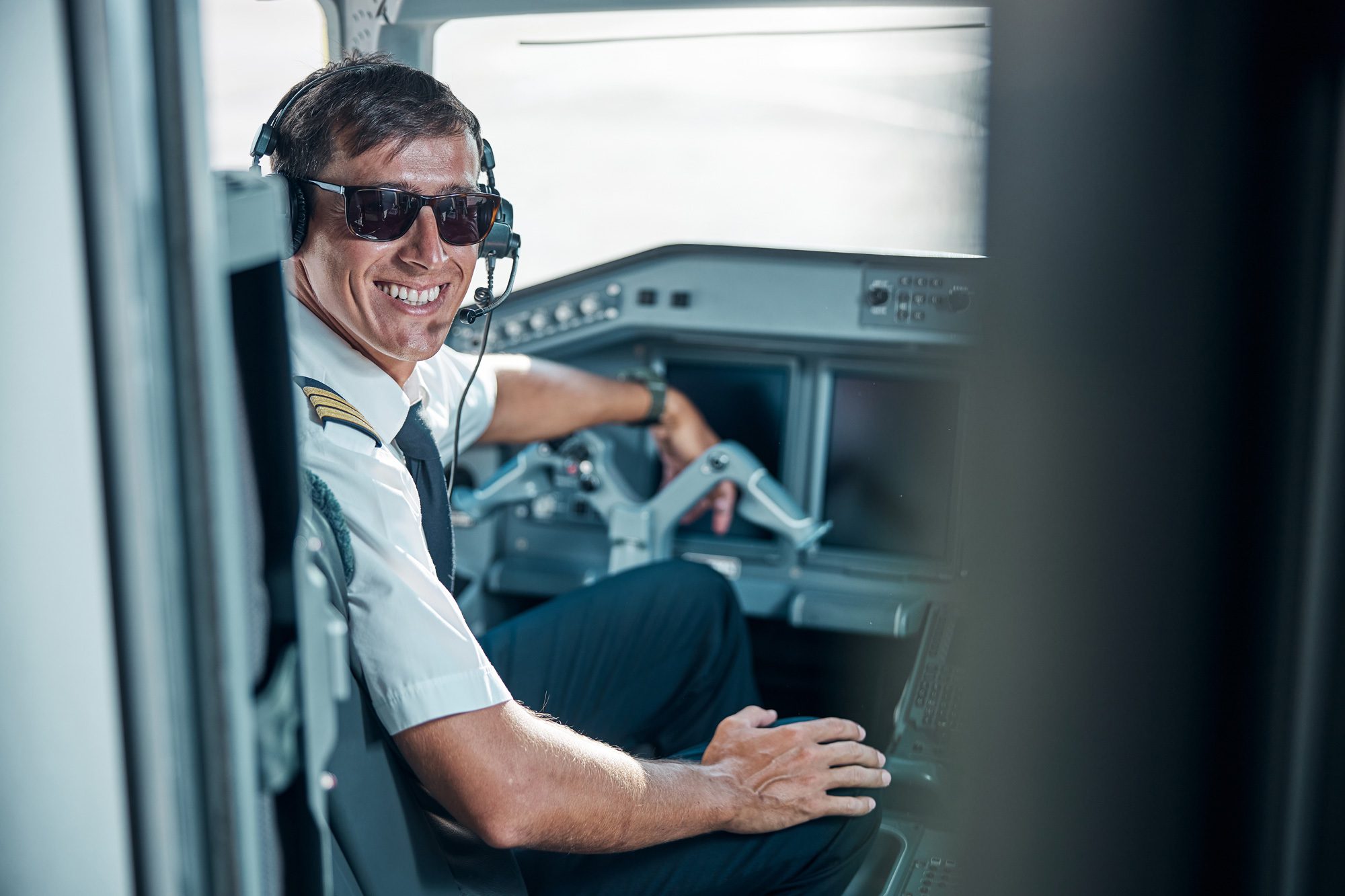 smiling male airline pilot looking toward the camera. masters in management aviation leadership, university of Dubuque online 